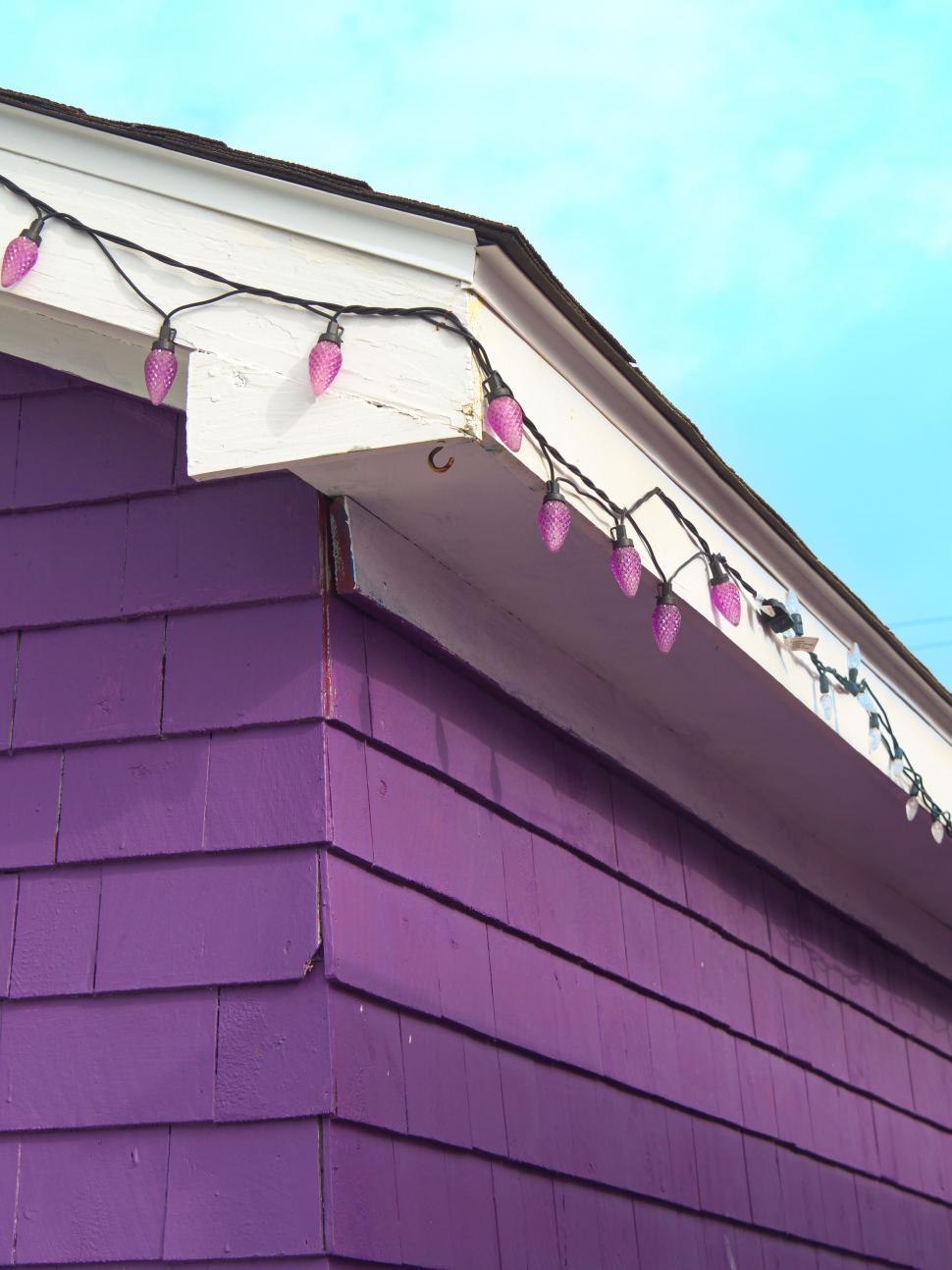 Free Image of Purple house with festive lights 