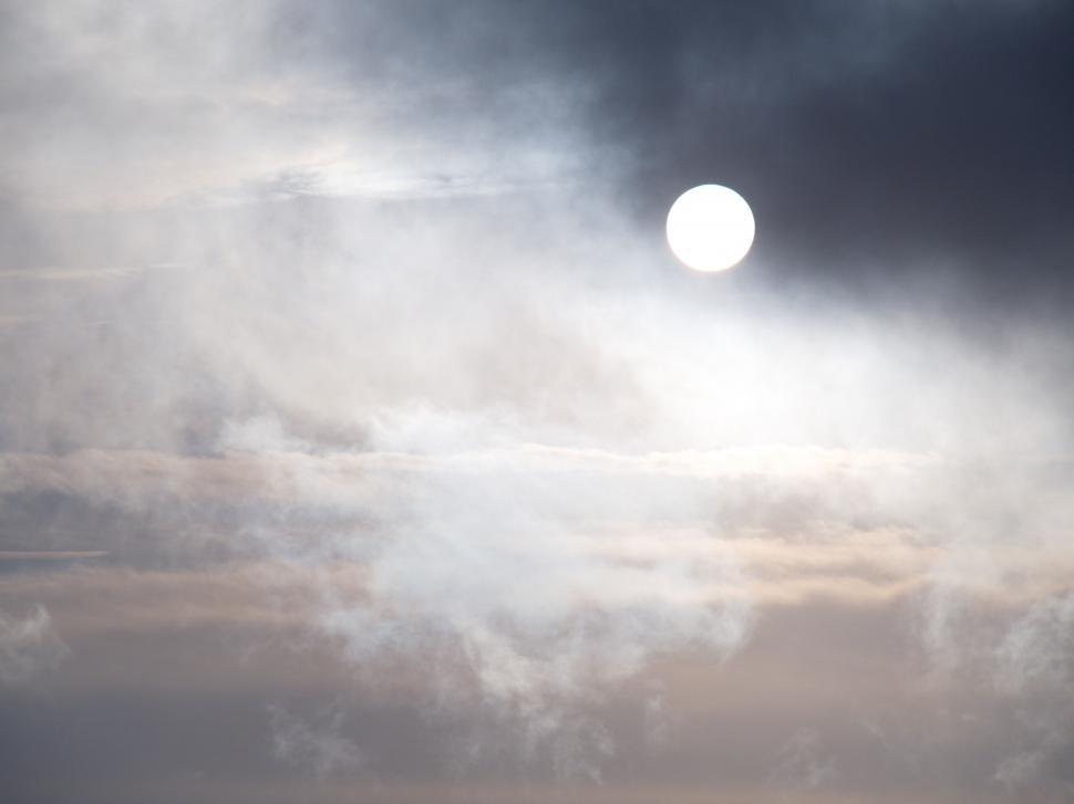 Free Image of Sun hidden by clouds in a dramatic sky 