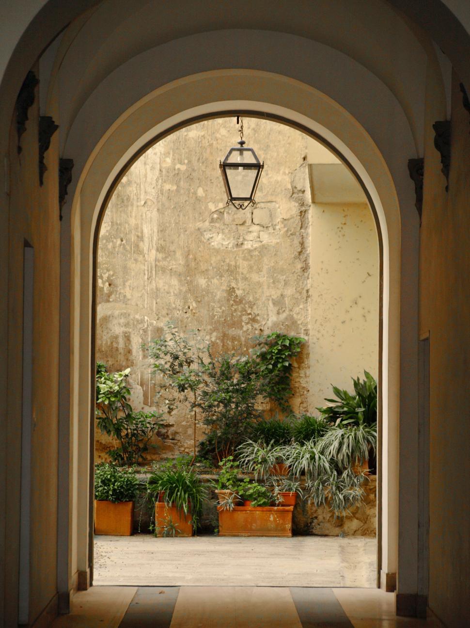 Free Image of Arched entrance to a serene courtyard 