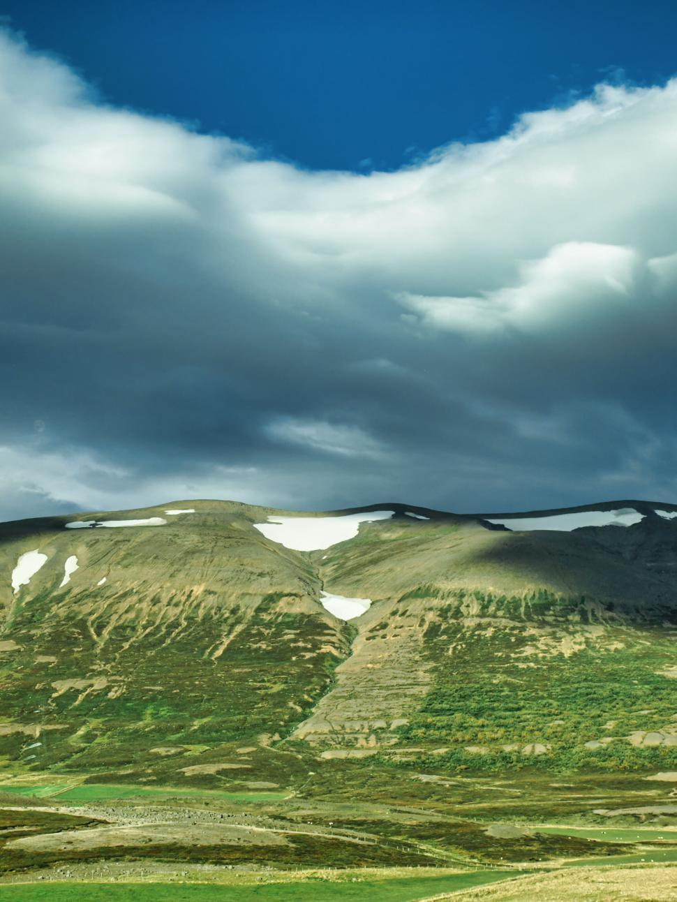 Free Image of Mountain landscape under a dramatic sky 
