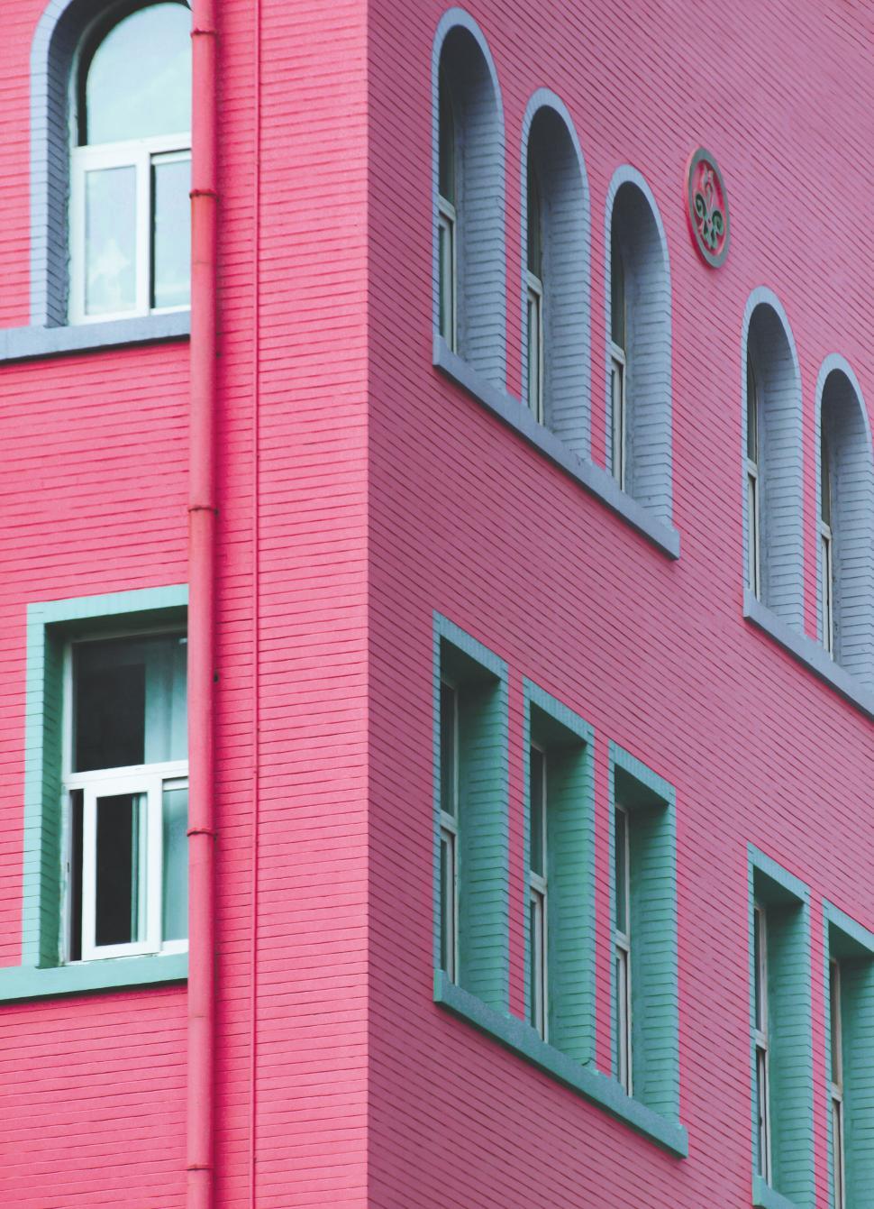 Free Image of Vibrant pink building with teal windows 