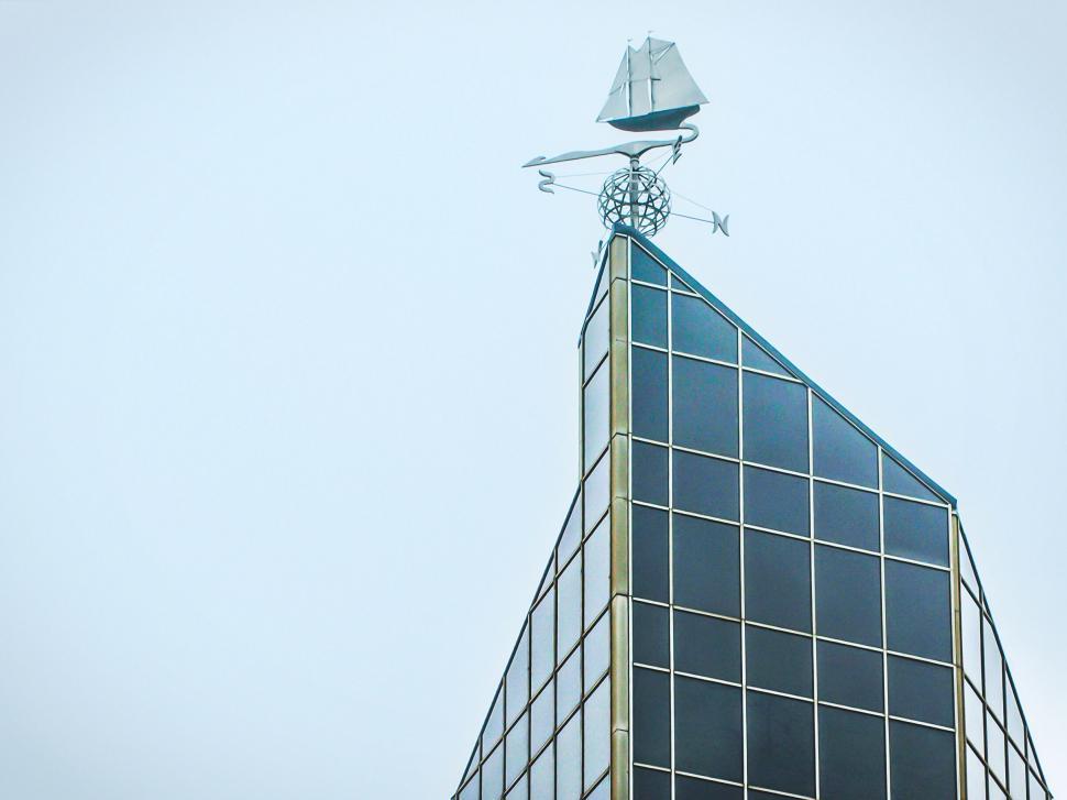Free Image of Sailing ship weathervane on glass building 