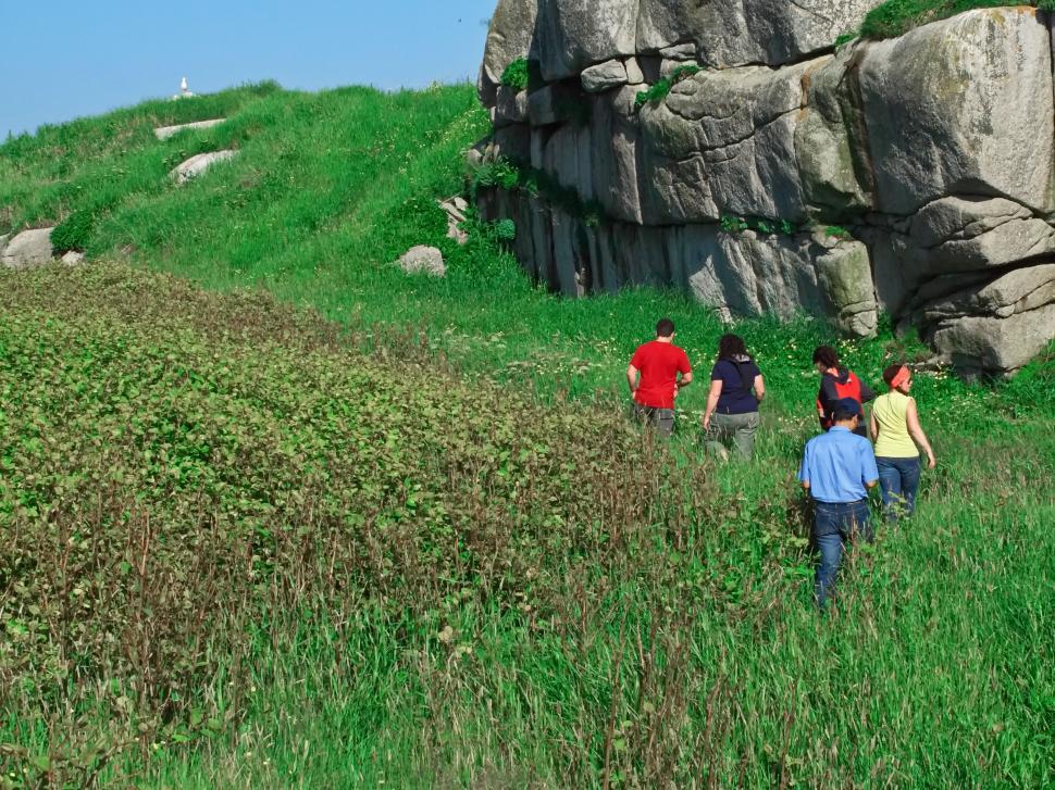 Free Image of Group of people hiking by rocky outcrop 