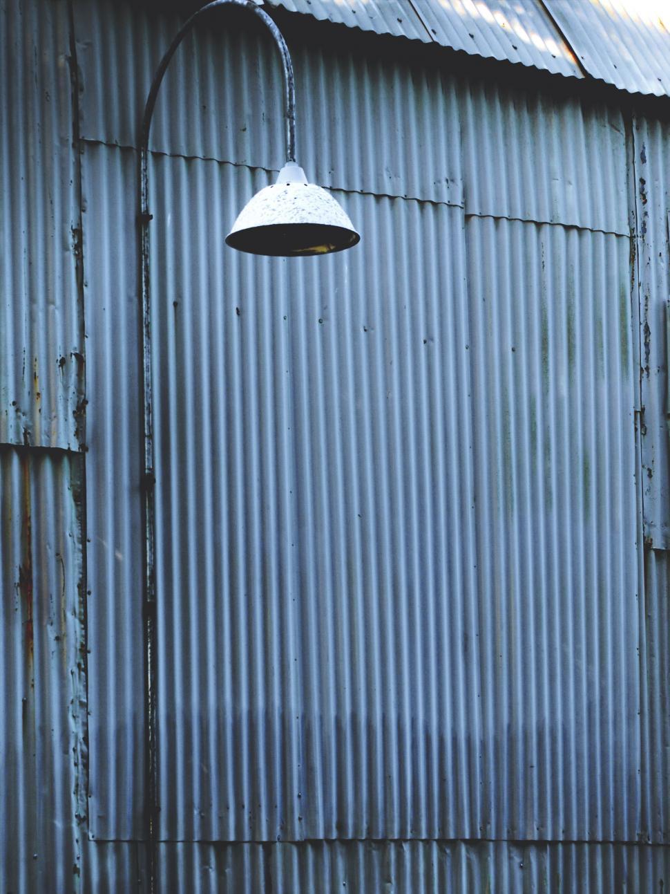 Free Image of Lamp post on an industrial metal wall 