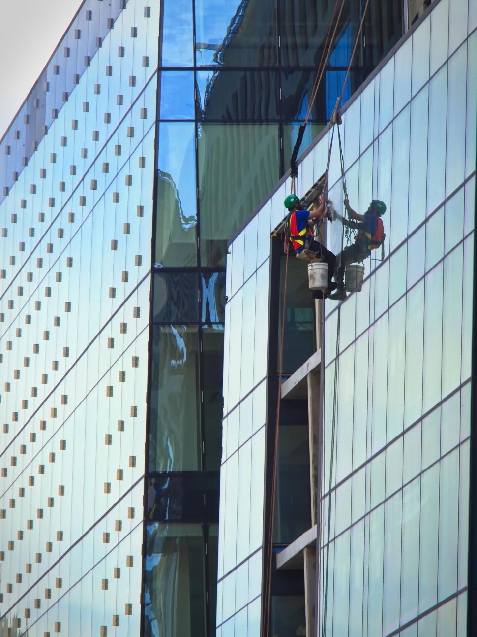 Free Image of Window washer on high-rise building facade 