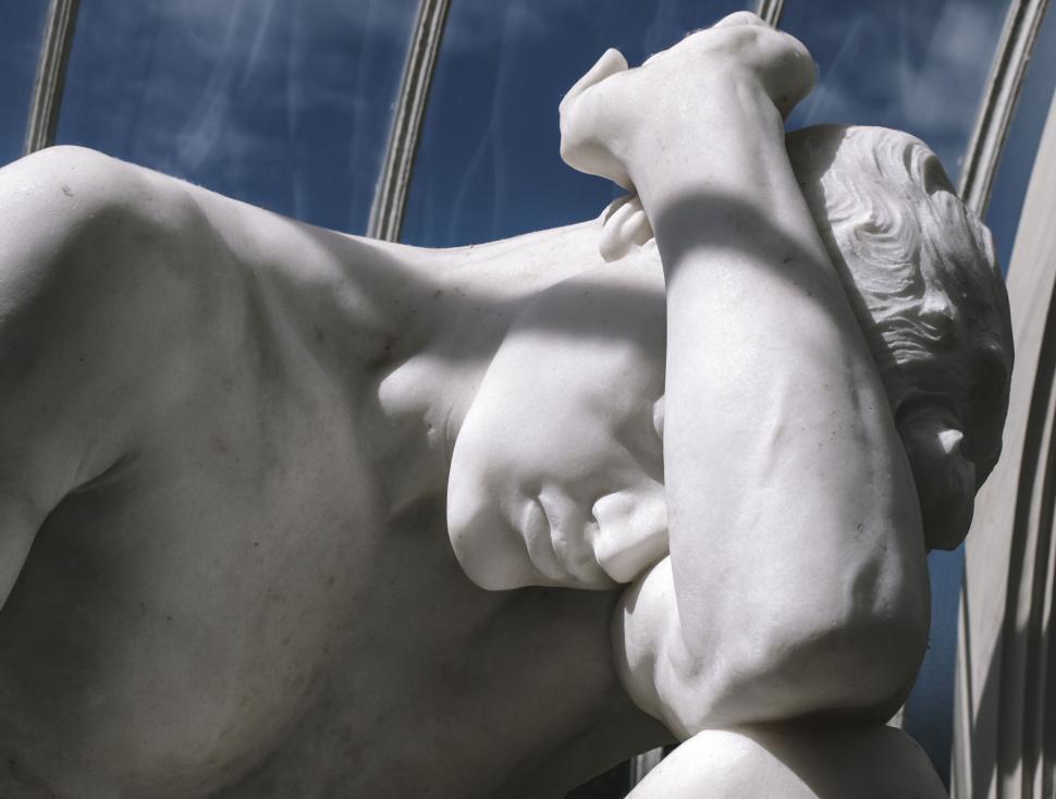 Free Image of Classic marble statue of a reclining figure 