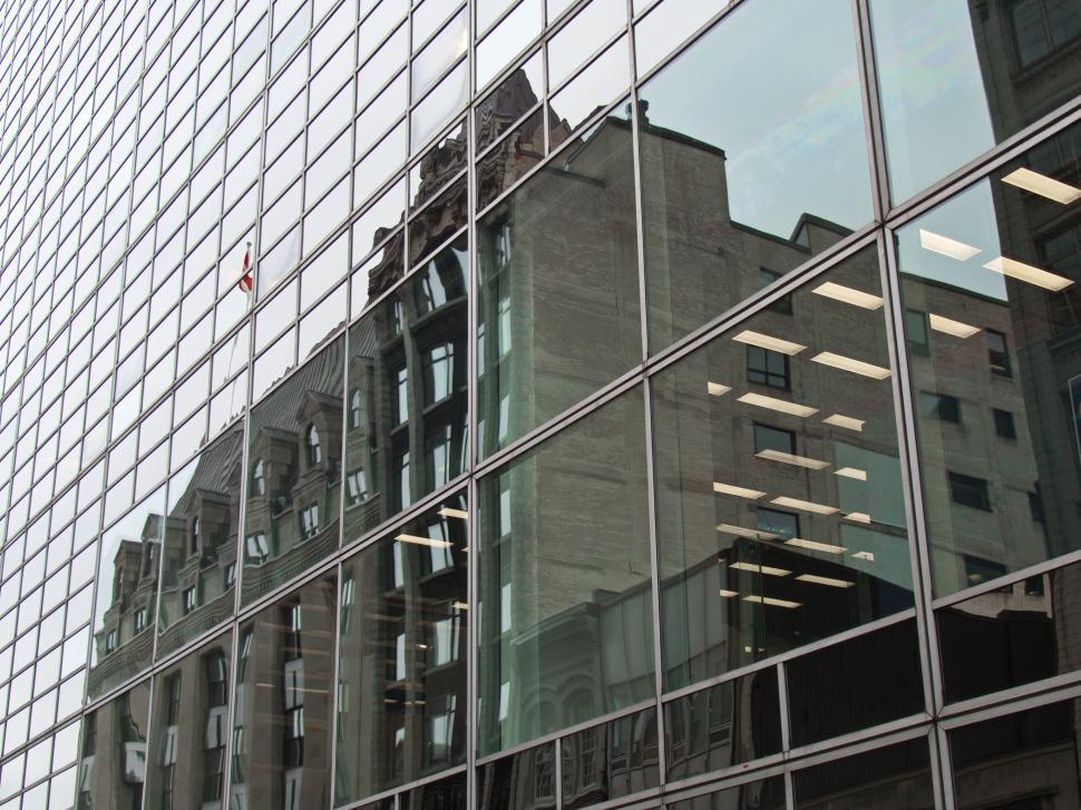 Free Image of Reflection of historic building in modern glass 
