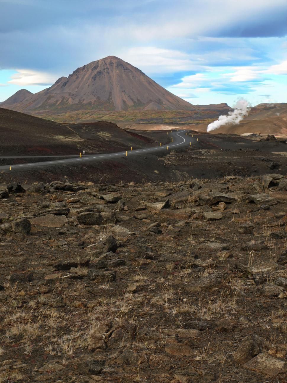 Free Image of Winding road leading towards a distant volcano 