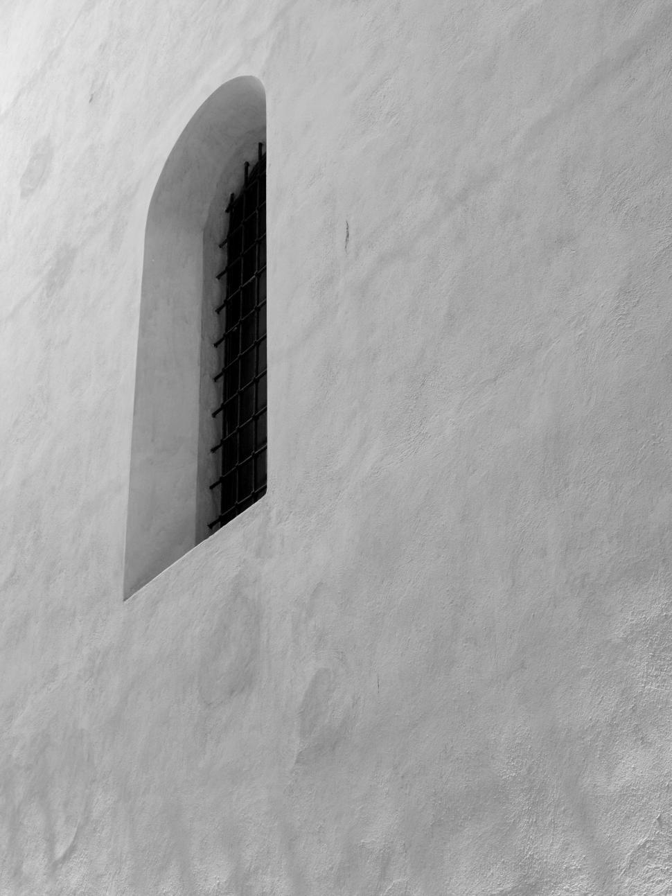 Free Image of Old window on a white stucco wall 
