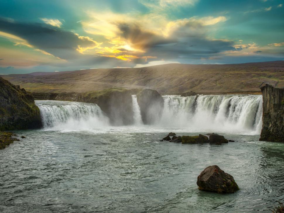Free Image of Majestic waterfall with sunset in Iceland 