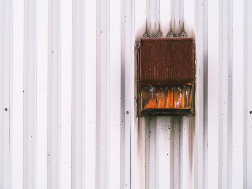 Free Image of Weathered rusty vent on corrugated wall 