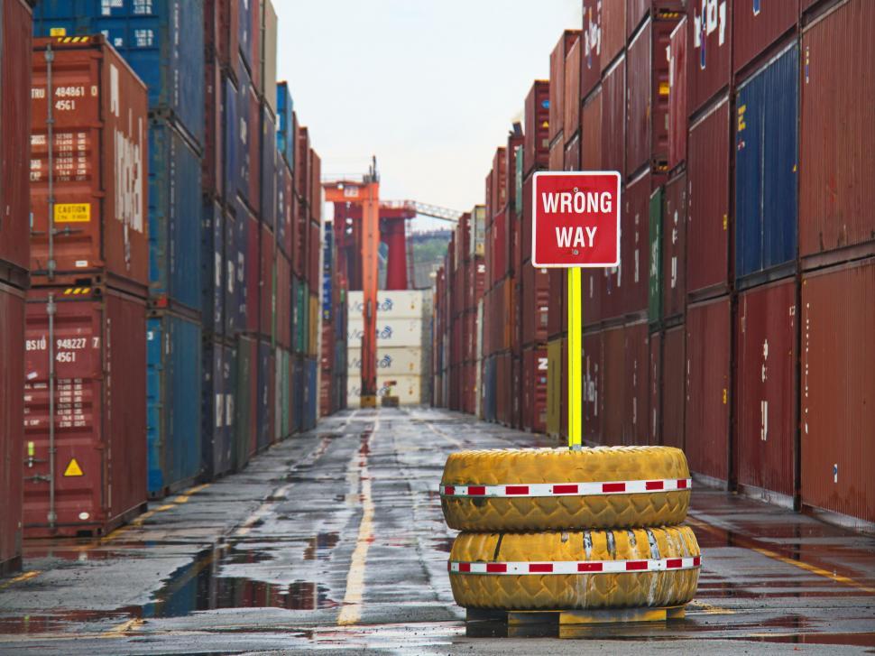 Free Image of Wrong way sign between stacked containers 