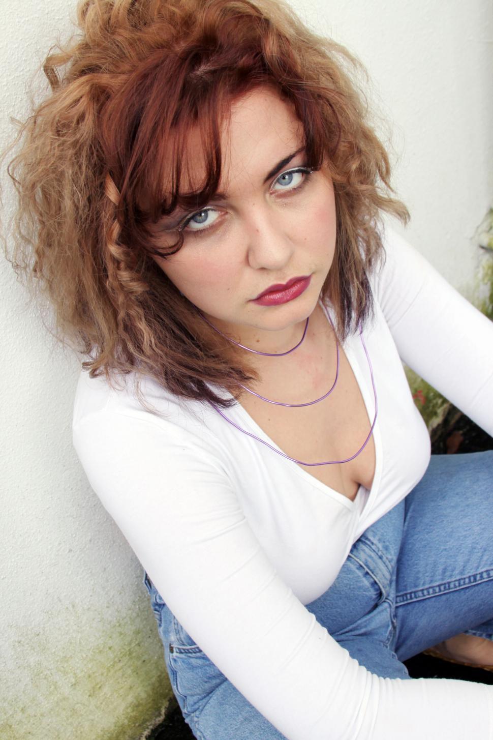 Free Image of Serious woman with piercing gaze in white top 