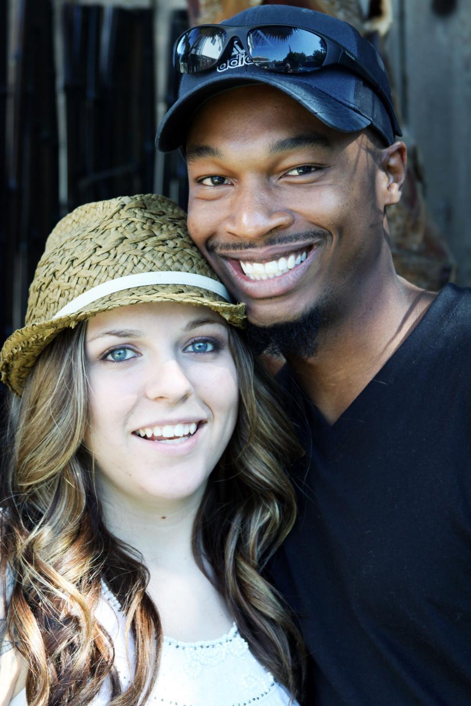 Free Image of Couple smiling with man wearing cap 