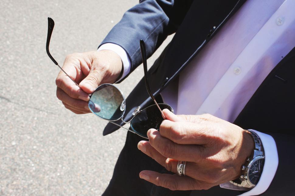 Free Image of Businessman holding sunglasses in daylight 