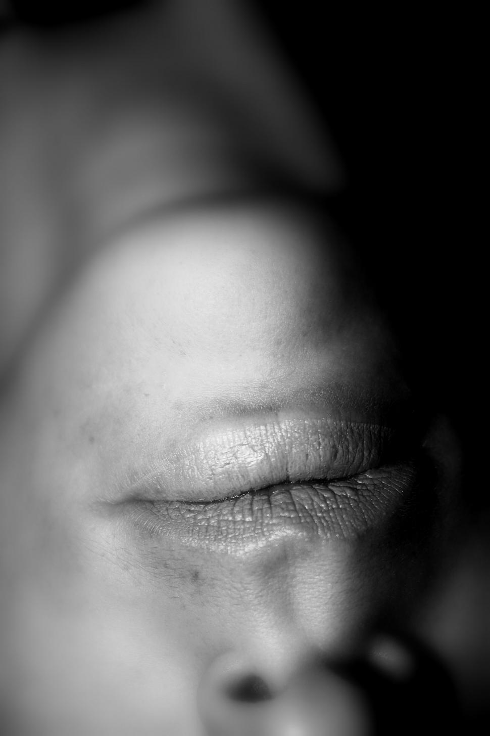 Free Image of Close-up of woman s closed mouth in shadow 