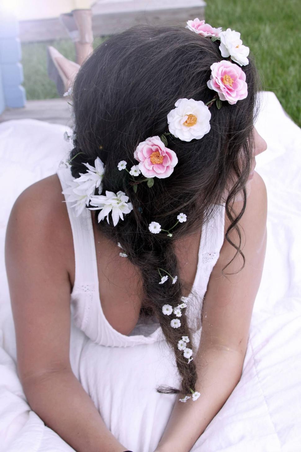 Free Image of Woman with flowers in braided hair 
