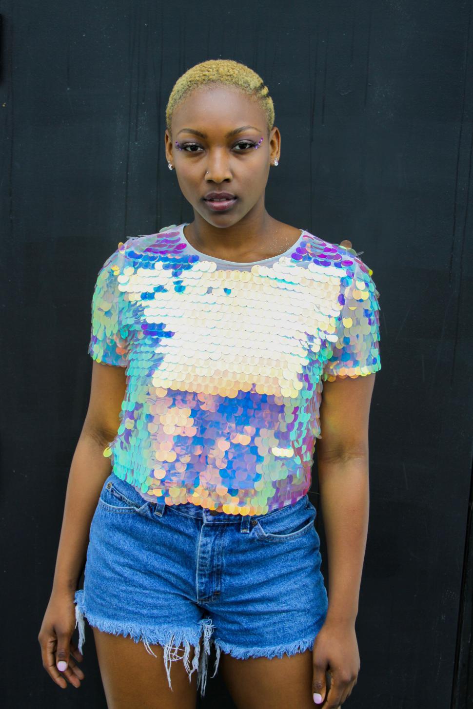 Free Image of Vibrant woman in sequined top and denim 