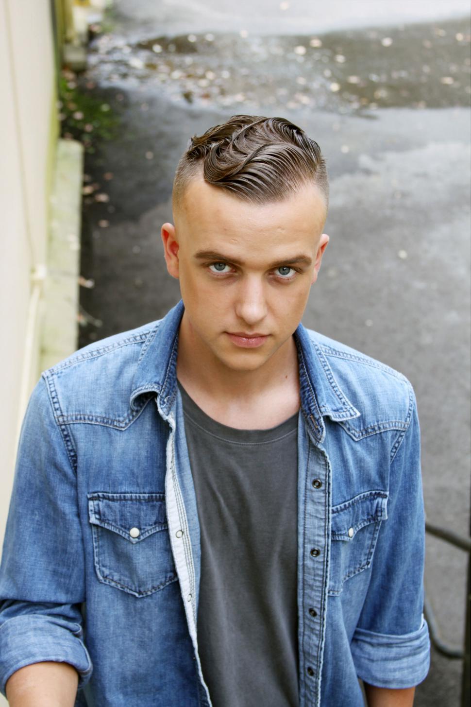 Free Image of Young man in denim jacket looking at camera 