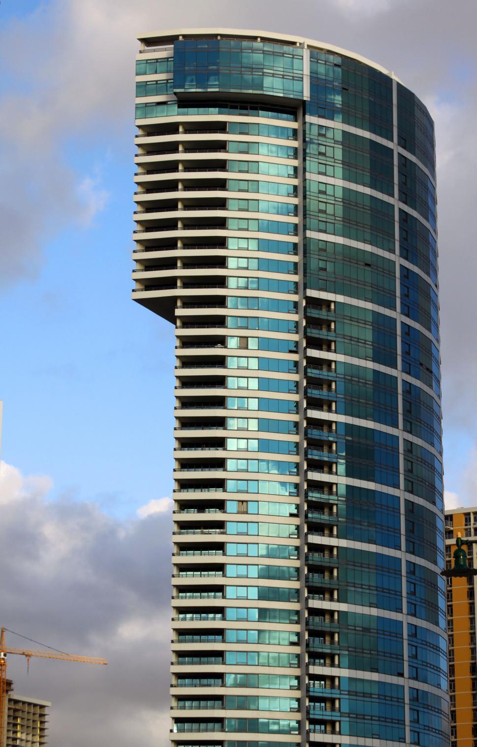 Free Image of Curved High-Rise Building against Cloudy Sky 