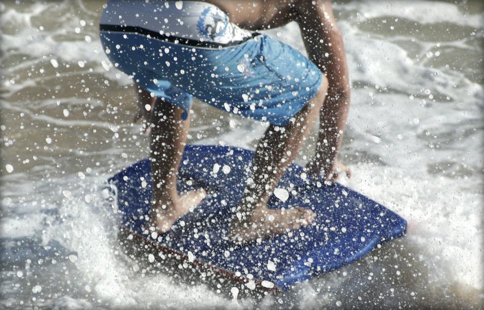 Free Image of Focused splash around surfer on bodyboard 