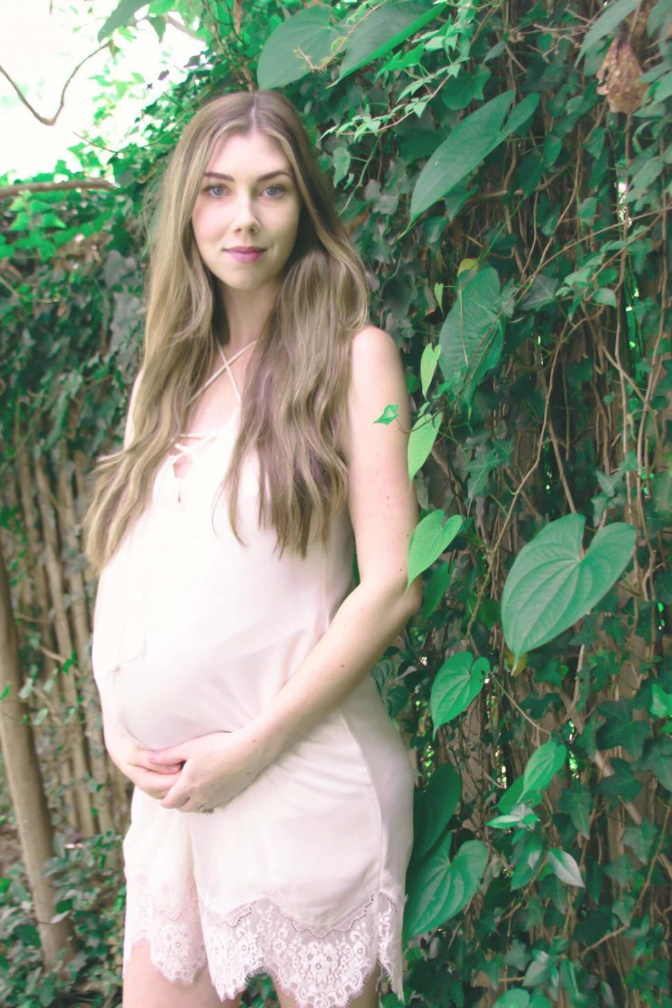 Free Image of Pregnant woman in a soft pink dress 