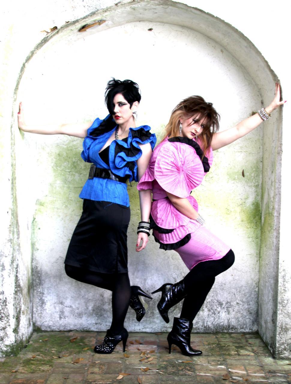 Free Image of Two women posing in vibrant outfits 