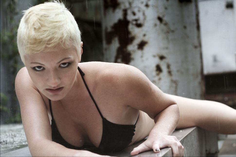 Free Image of Blonde woman posing in gritty urban scene 