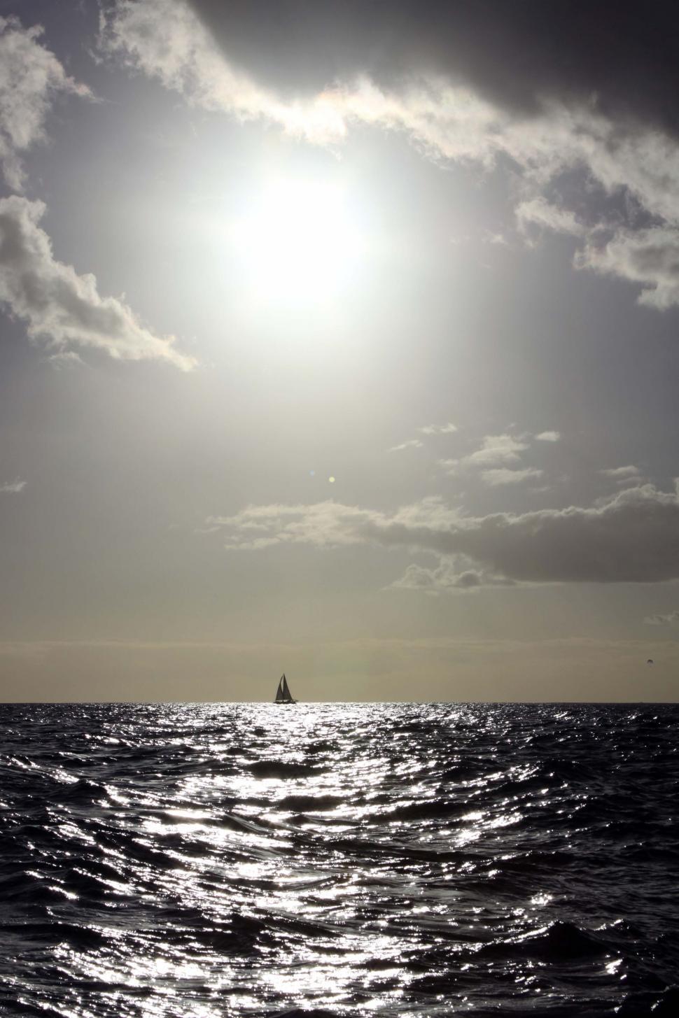 Free Image of Sailboat on Sunlit Ocean Horizon 
