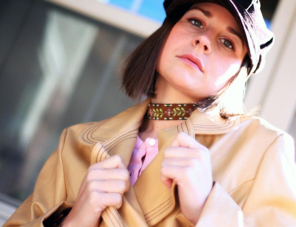 Free Image of Person adjusting collar of chic leather coat 