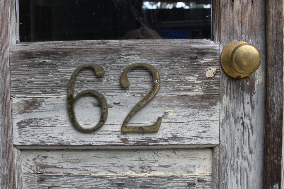 Free Image of Vintage door with brass number 62 