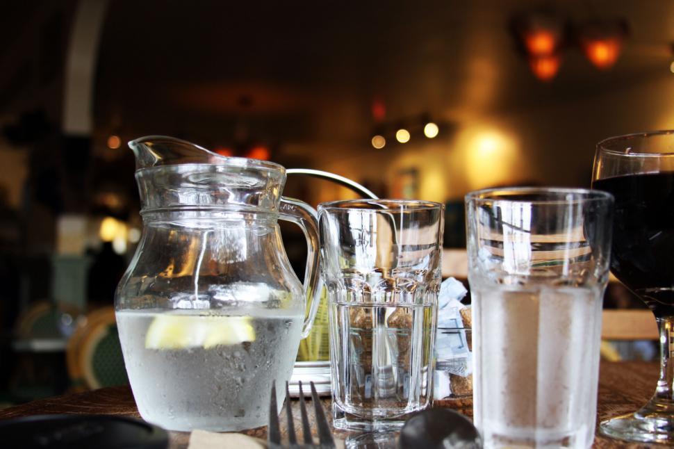 Free Image of Pitcher of water and glasses on a restaurant table 