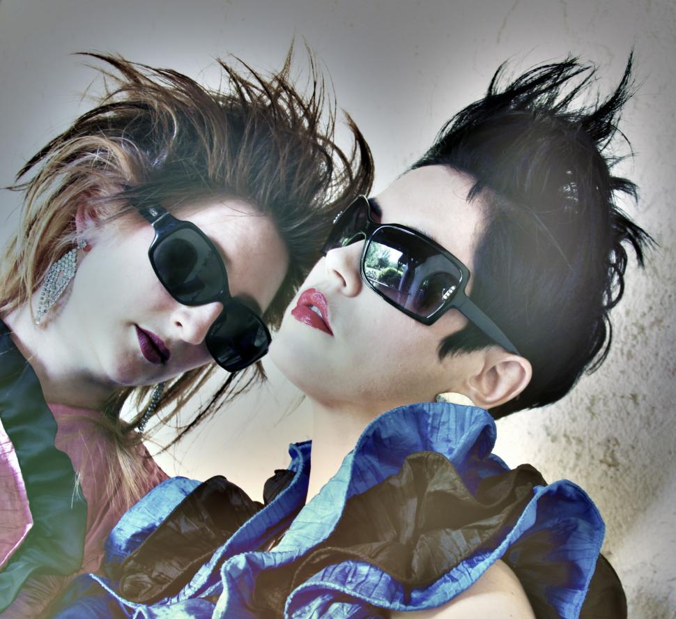 Free Image of Two Women with Dramatic Hair and Sunglasses 