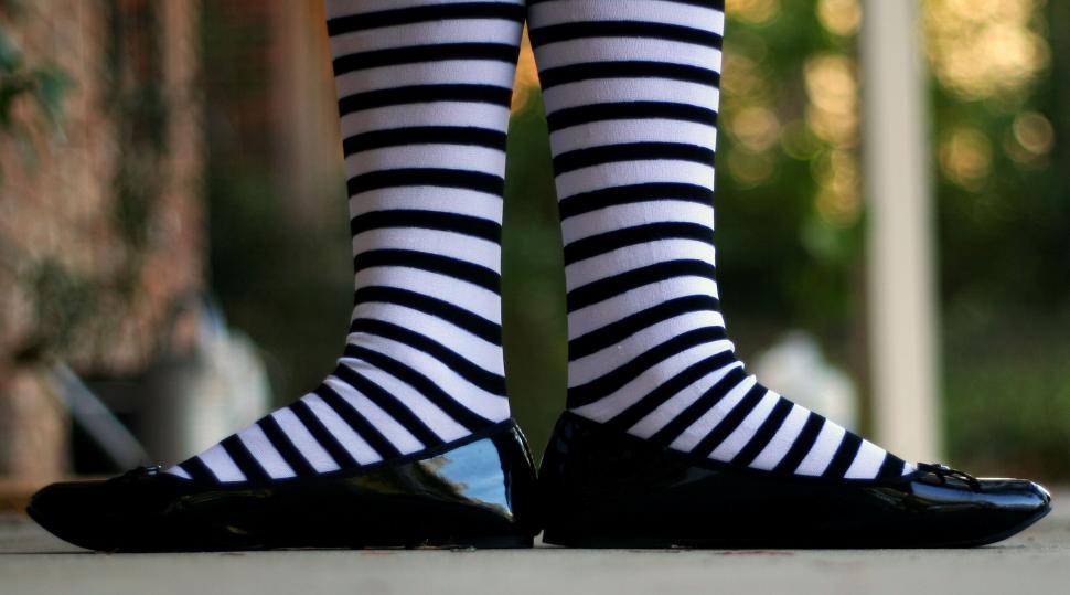 Free Image of Person Wearing Striped Socks and Shiny Shoes 