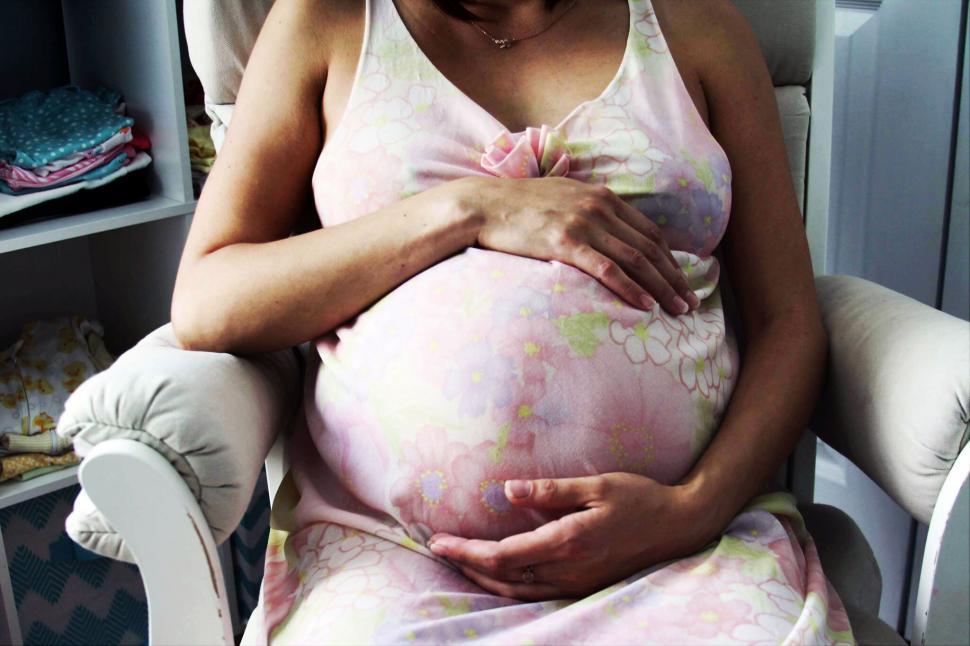 Free Image of Pregnant woman touching belly 