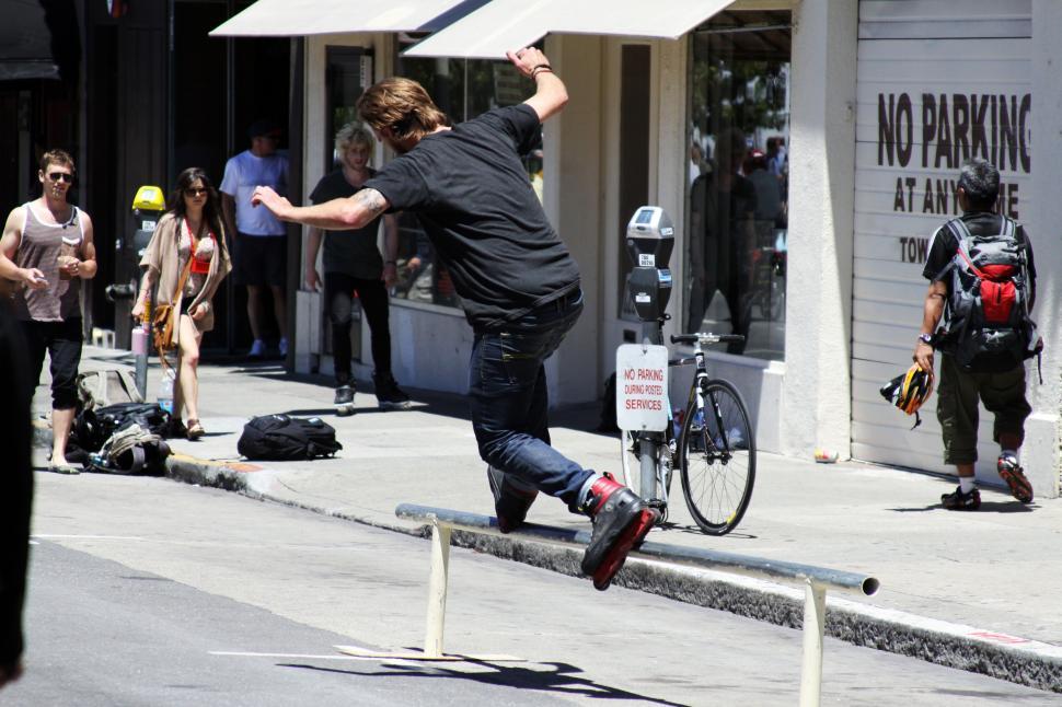 Free Image of Skater jumping over a rail in urban setting 