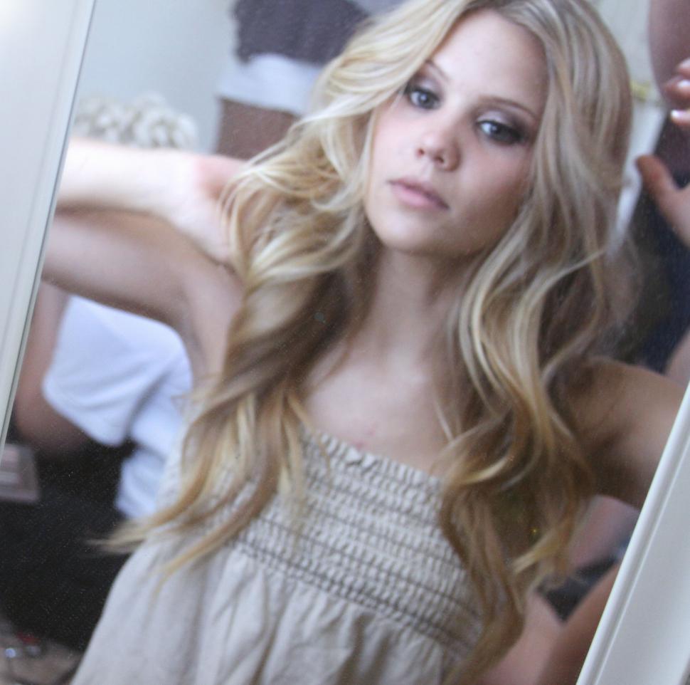 Free Image of Blonde woman looking into a mirror 