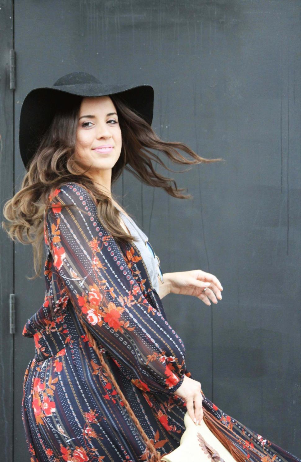 Free Image of Pregnant woman in floral dress with cowboy hat 
