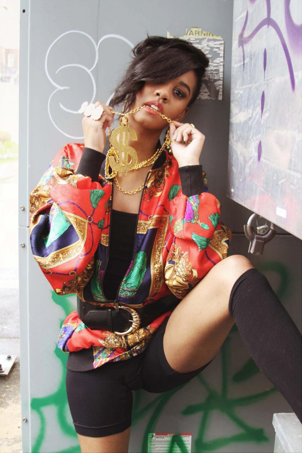 Free Image of Stylish person in colorful jacket poses in city 