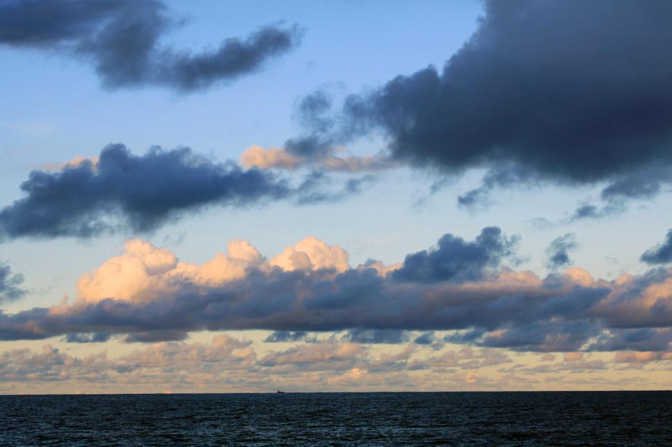 Free Image of Scenic cloudscape over tranquil open waters 