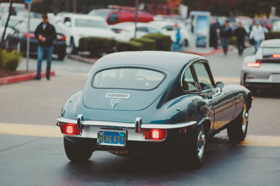 Free Image of Vintage car rear view on a busy street 