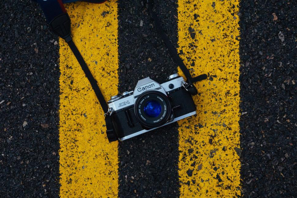 Free Image of Vintage Canon Camera on Yellow Lines 