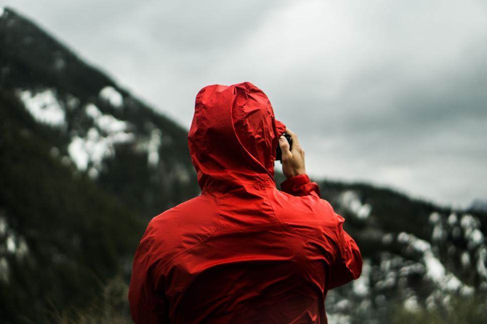 Free Image of Person in red jacket looking at mountains 