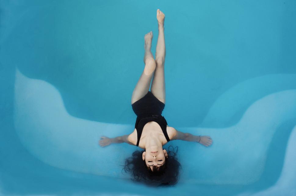 Free Image of Serene Person Floating in Tranquil Pool 