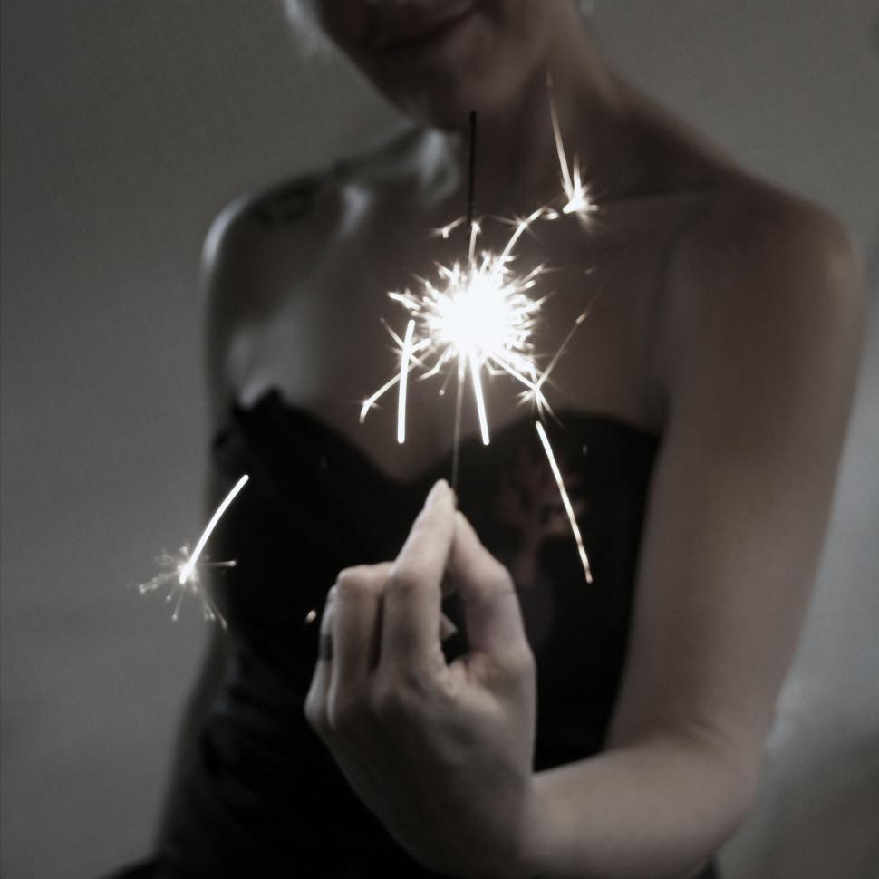 Free Image of Woman holding a sparkler gracefully 