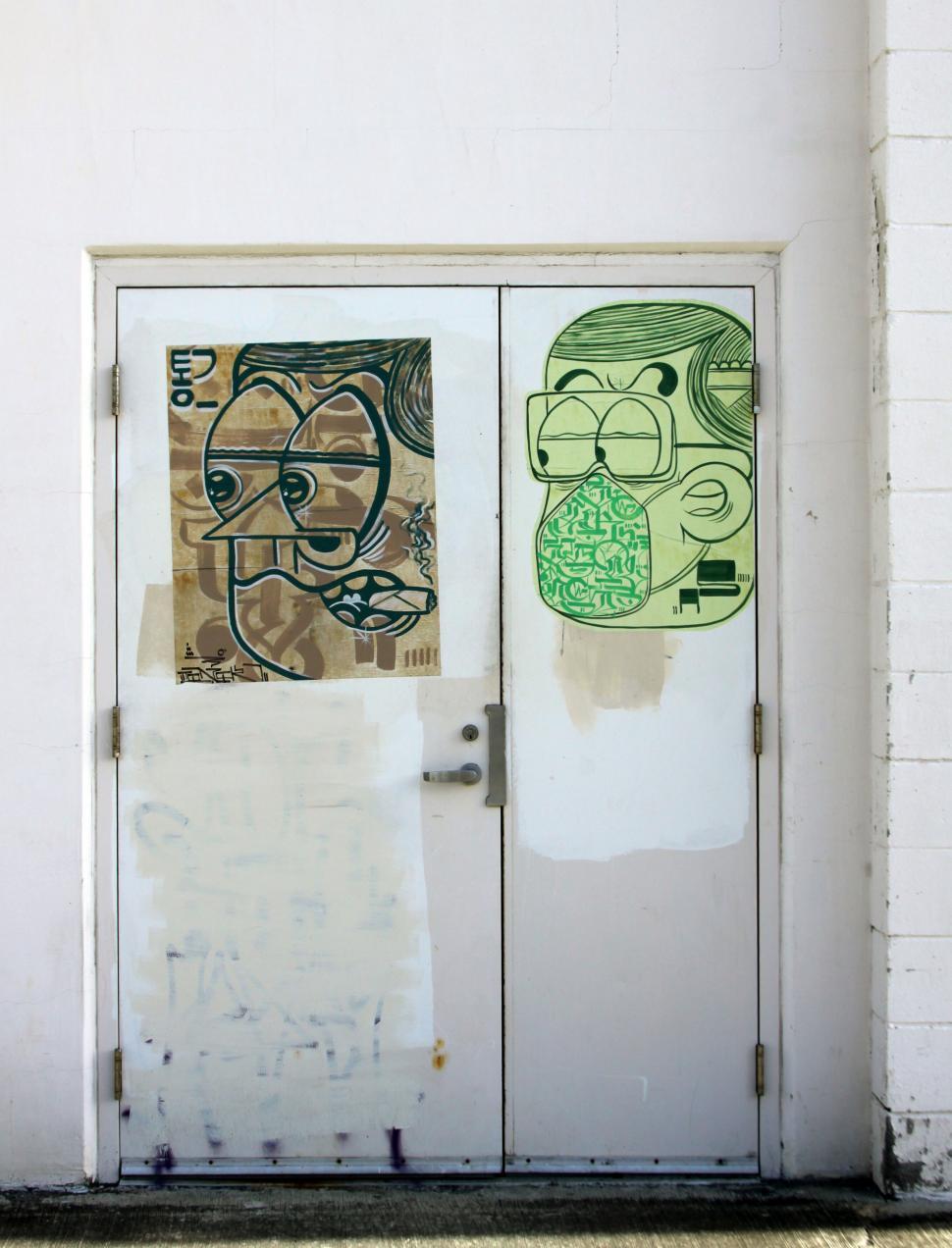 Free Image of Graffiti art on a pair of urban doors 