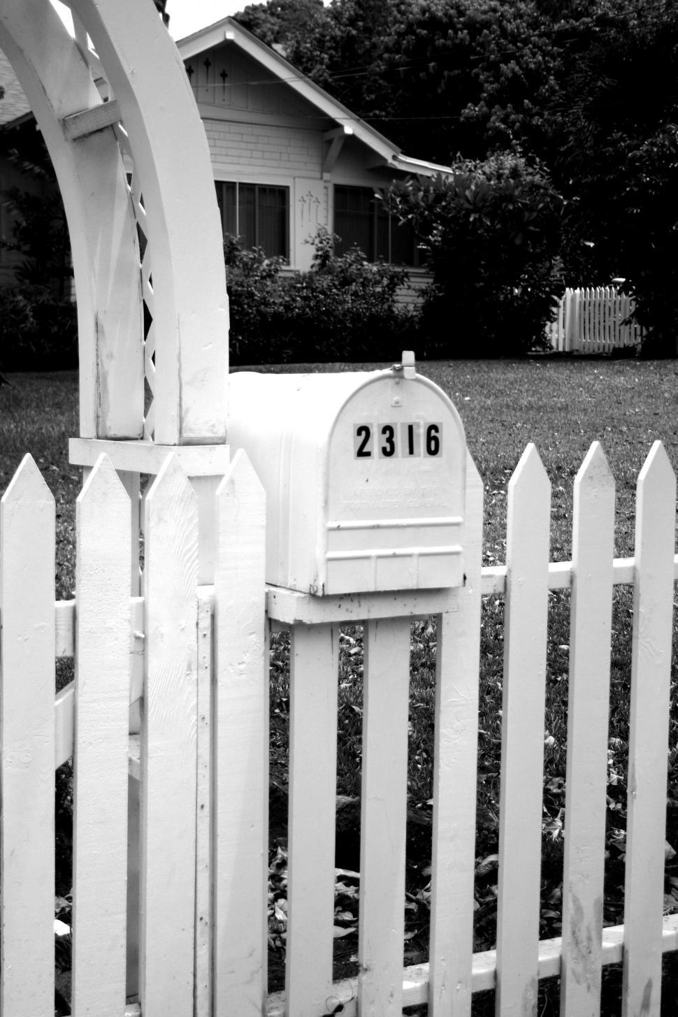 Free Image of Monochrome mailbox by white picket fence 