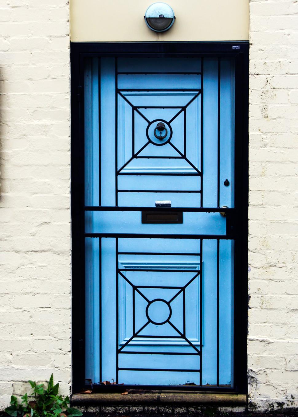 Free Image of Blue door with geometric design and knocker 