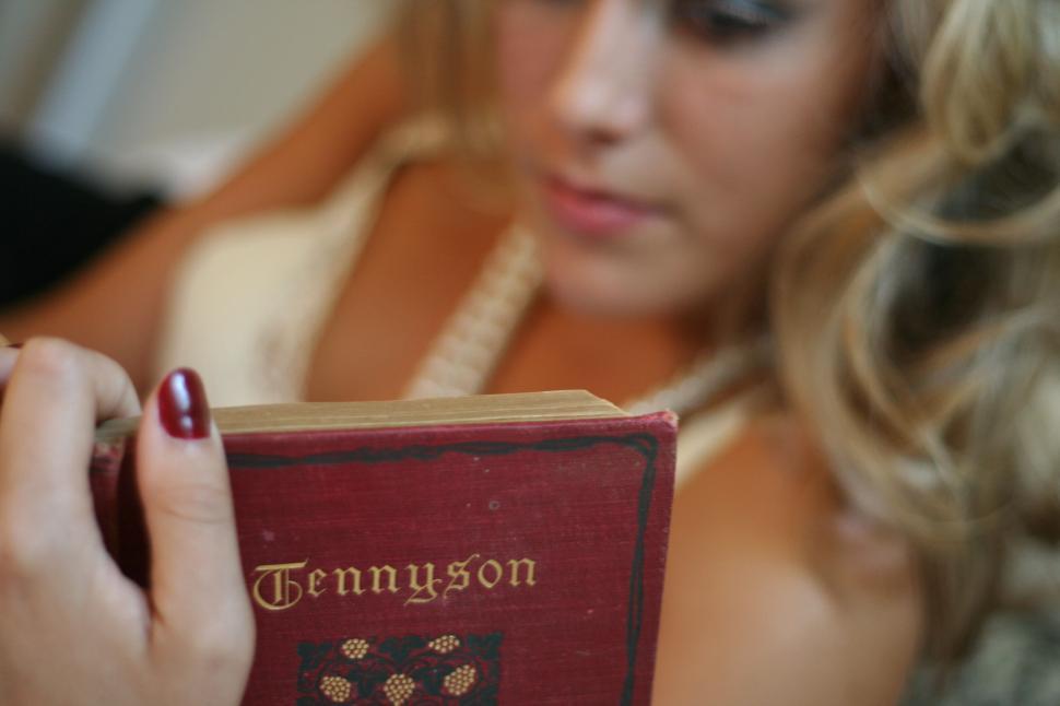 Free Image of Intimate reading of a vintage Tennyson book 