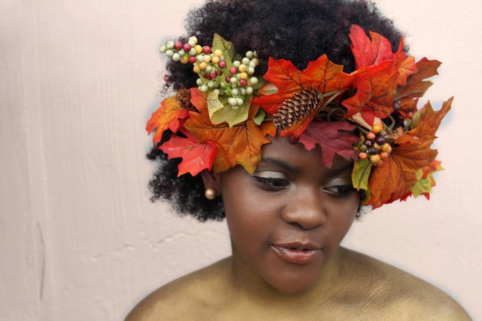 Free Image of Person with autumn leaves headpiece looking down 